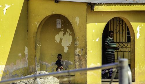 Man and boy in corridor of building