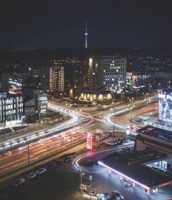High angle view of illuminated city street and buildings at night