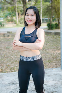 Portrait of a smiling young woman standing outdoors