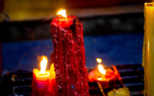 Close-up of lit candles in temple