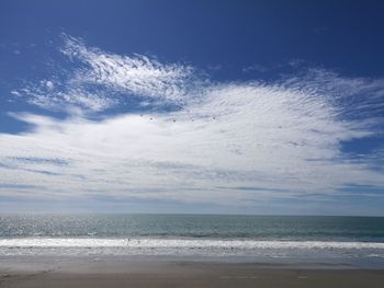 Scenic view of sea against blue sky