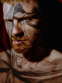 Young bearded man portrait, red hair, layered, body paint, traces, psychology, looking at camera