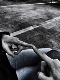 Close-up of person holding hands on street