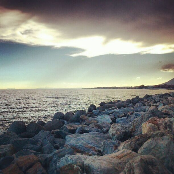 sea, water, sky, scenics, tranquil scene, beauty in nature, horizon over water, tranquility, sunset, rock - object, cloud - sky, nature, sun, idyllic, shore, cloud, beach, cloudy, rock formation, sunlight