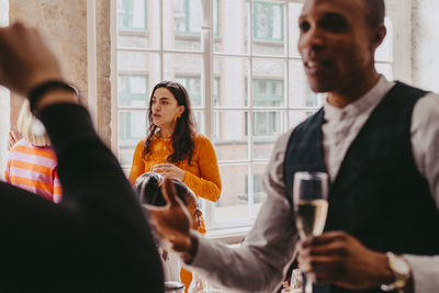 Male and female business colleagues attending event at convention center