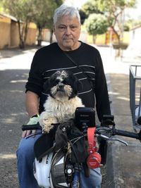 Portrait of man riding dog