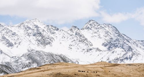 Scenic view of snowcapped mountains against sky