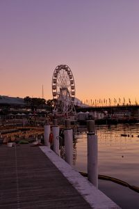 Ferris wheel in city at sunset