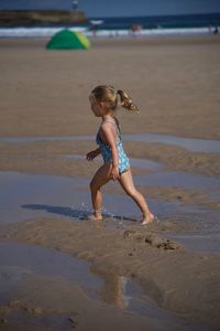 Full length of girl walking at beach