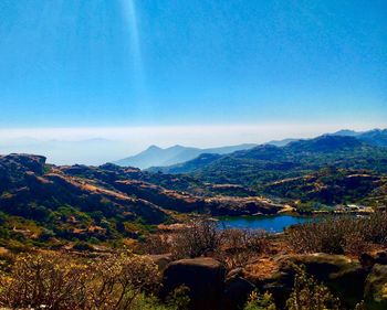 Scenic view of mountains against blue sky