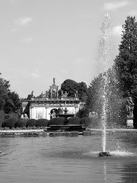 Fountain in front of built structure against sky