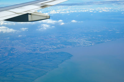 Aerial view of clouds over landscape and sea