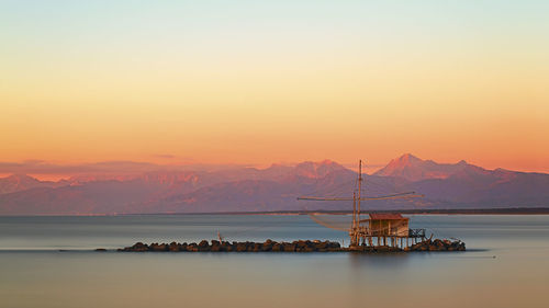 Scenic view of sea against clear sky during sunset