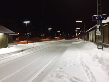 Snow covered road at night