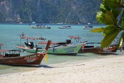 Boats moored on beach