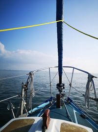 Low section of person sailing on sea against sky