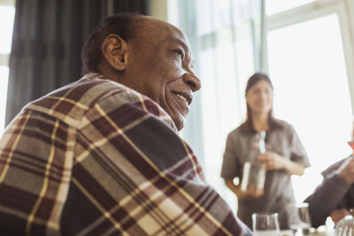 Contemplative senior man looking away at retirement home