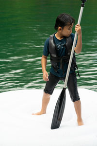 Full length of boy holding water