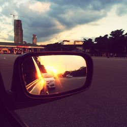 Cars on road at sunset