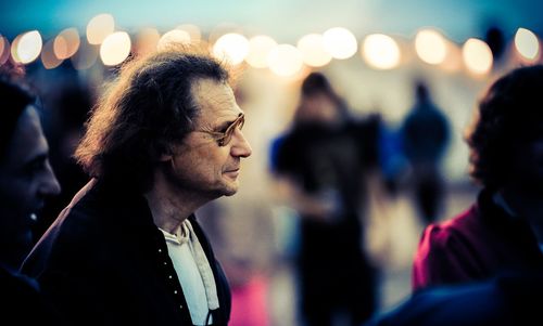 Close-up of mature men in concert at dusk