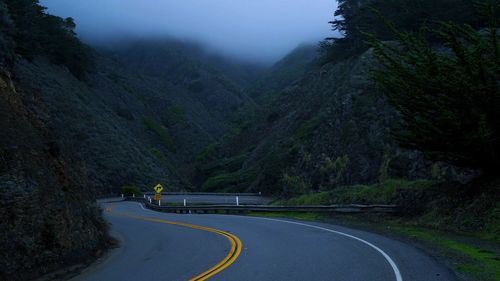 Road amidst mountains against sky