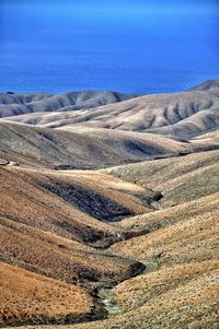 Scenic view of landscape against blue sky