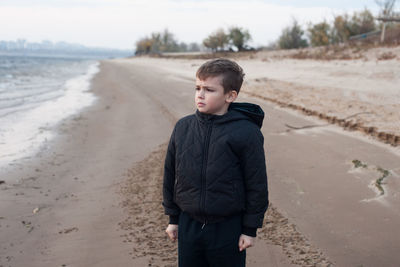Boy standing on beach