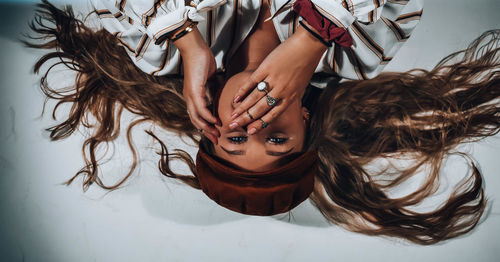 Upside down image of young woman wearing hat