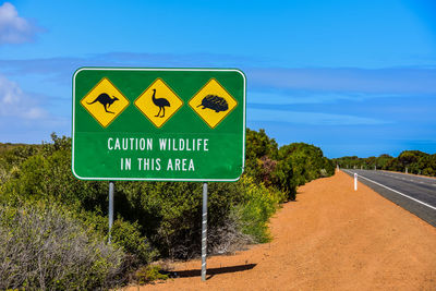 Road sign against blue sky