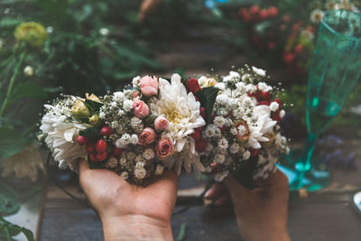 Close-up of hand holding flower bouquet