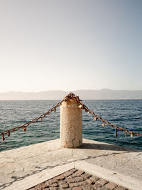 Pier over sea against clear sky