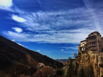 Buildings against cloudy sky