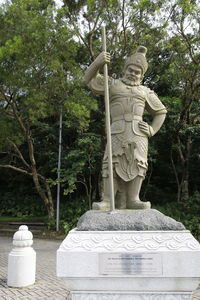 Statue against trees