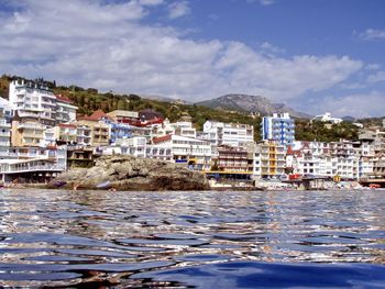 Town by sea against sky