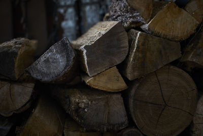 Close-up of stacked logs in storage room