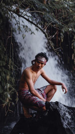 Man sitting on rock