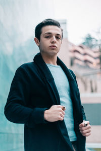 Portrait of young man standing outdoors