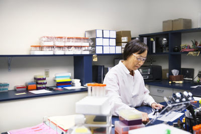 Senior female scientist performing experiment in laboratory