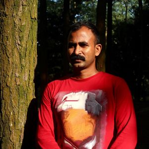 Portrait of young man in forest