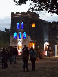 People in front of built structure