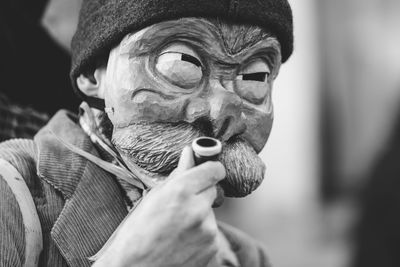 Ancient carnival of sauris. traditional wooden masks. black and white. italy