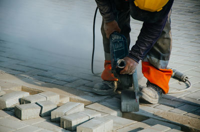 Low section of man standing on sidewalk