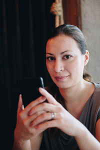 Woman using mobile phone in home