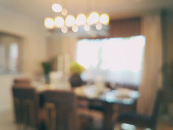 Defocused image of empty chairs and table in restaurant