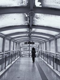 Rear view of woman walking in corridor