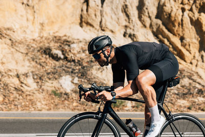 Man riding bicycle on road