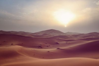 Scenic view of desert against sky during sunset