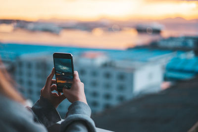 Man photographing with mobile phone in water