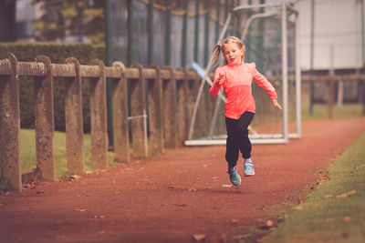 Full length of young woman running