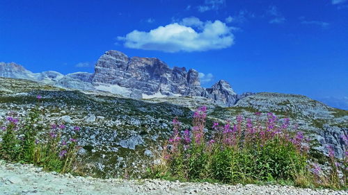 Scenic view of mountains against blue sky